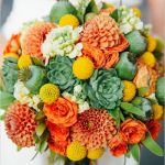 green succulents yellow billy balls and coral roses wedding bouquet