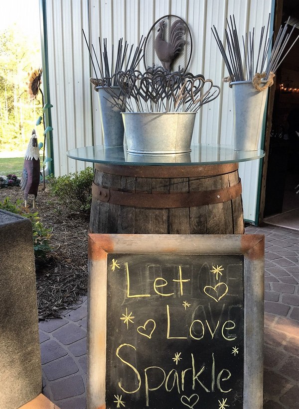 Rustic themed display for sparklers in galvanized steel containers