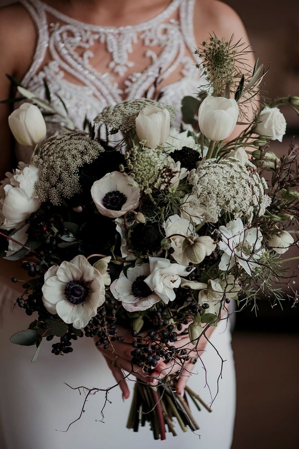 Wild bohemian bouquet featuring white hellebores, black roses, tulips, peonies and Queen Anne’s lace